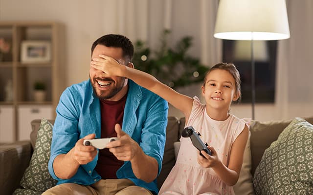 Father-daughter playing video games
